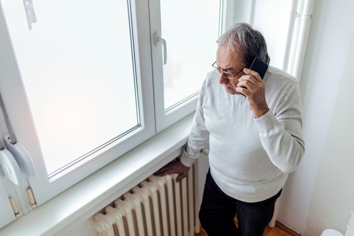 heat not working in house Cropped shot of an old men suffering cold at home and having problem with house heating, calling repair service for help.