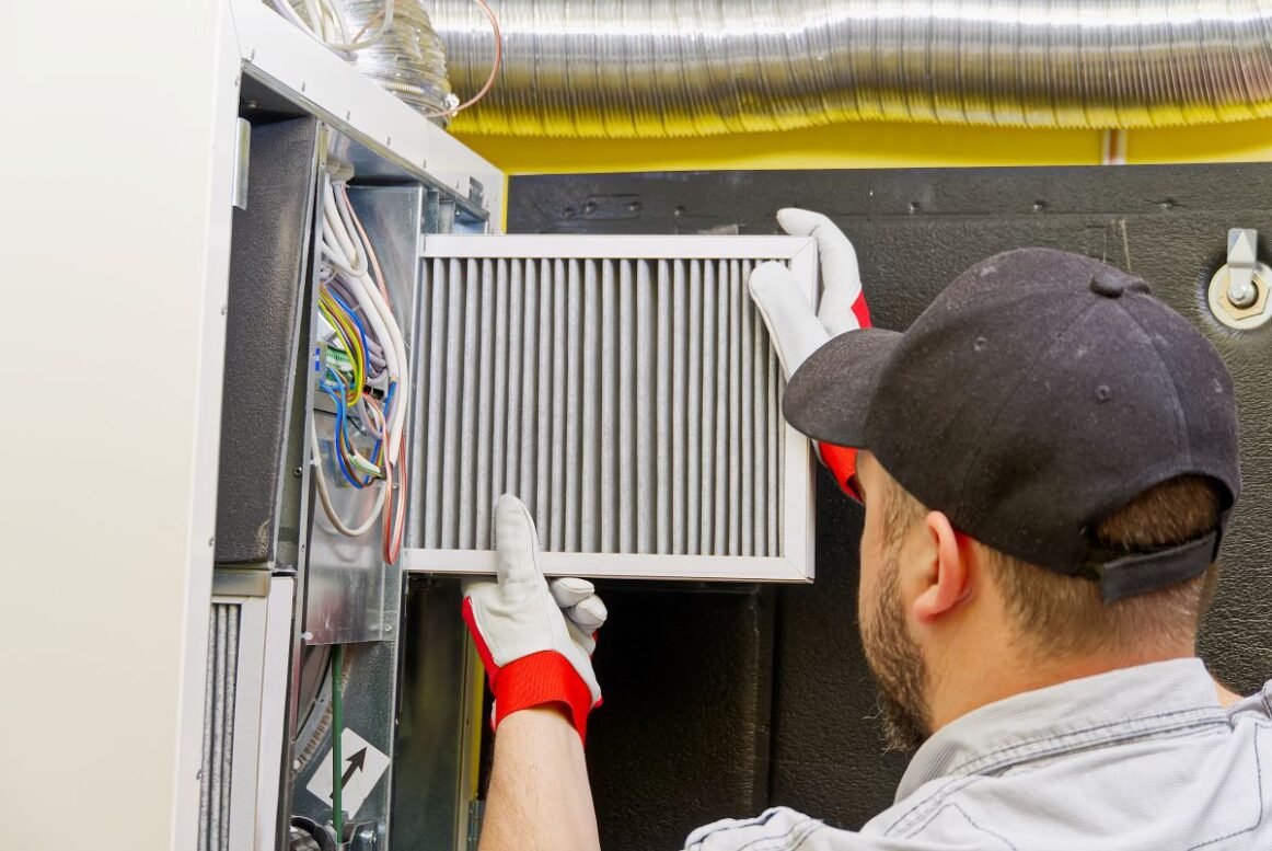 service technician changing dirty air filter