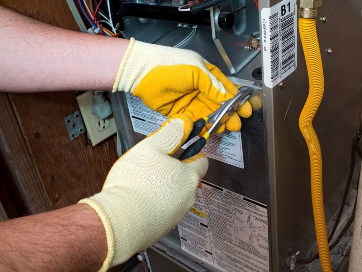 furnace smells like burning worker repairing AC